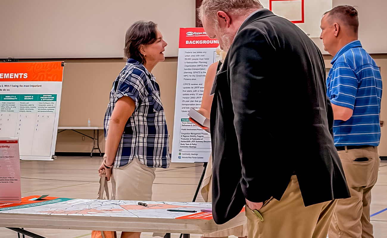 Staff and attendees mingling at Powdersville public meeting.